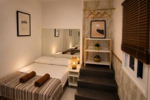 two beds in a small room with a staircase at Kite & Surf Nomad House in Las Palmas de Gran Canaria