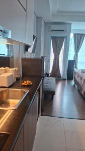 a kitchen with a sink and a room with a bed at wyndham panbil sanctuary in Kangboi