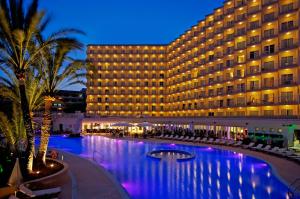 a hotel with a swimming pool in front of a building at SOL by Meliá Guadalupe in Magaluf