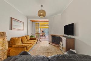 a living room with a couch and a flat screen tv at Azeitão Town House in Azeitao