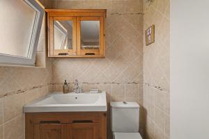 a bathroom with a sink and a toilet at Azeitão Town House in Azeitao +24 photos
