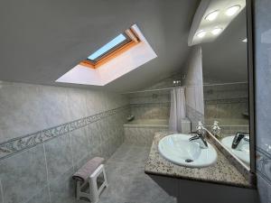 a bathroom with a sink and a skylight at El abrazo de La Yecla in Espinosa de Cervera +40 photos