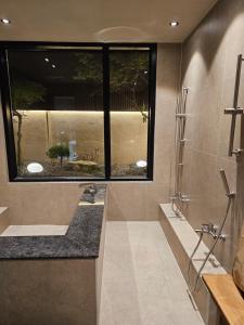 a bathroom with a large window and a sink at 목포 미유스위트 호텔 in Taeban-dong