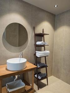 a bathroom with a sink and a mirror at 목포 미유스위트 호텔 in Taeban-dong