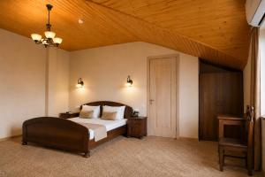 a bedroom with a large bed and a wooden ceiling at Hotel Imperial House in Tbilisi City