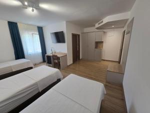 a hotel room with two beds and a kitchen at Hotel 81 in Međugorje