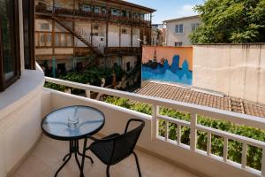 a balcony with a table and chairs on a building at Hotel Imperial House in Tbilisi City