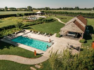 an overhead view of a swimming pool in front of a barn at Domaine Sur Les Sarts in Ohey