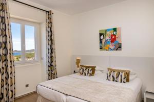 a bedroom with two beds and a window at Santateresa in Bonifacio