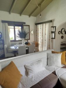 a living room with a couch and a dining room at Gal House in Bali