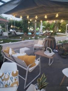 a patio with chairs and a table under a tent at Gal House in Bali