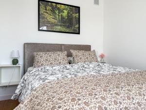 a bedroom with a bed with a comforter and pillows at Apartament Biłgorajski przy Rynku in Biłgoraj
