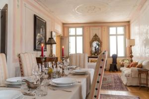 a dining room with a table with plates and wine glasses at Palazzo Benassi Nobile Dimora nel Cuore di Asolo in Asolo +61 photos