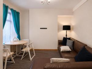 a living room with a couch and a table at 54 - Room 3 - City views in Swansea