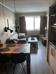 a living room with a table and a couch at Apartment in Gautefall in Drangedal