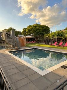 a swimming pool at a park with a playground at Chalet SEASIDE in Lathum