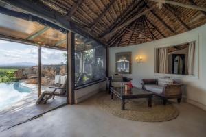 a living room with a view of the canyon at Elewana Elsa's Kopje in Meru +102 photos