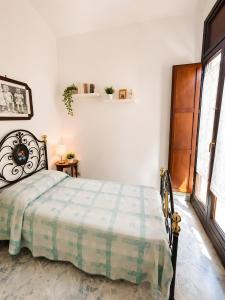 a bedroom with a bed in a room with a window at La Dimora del Colle in Mottola