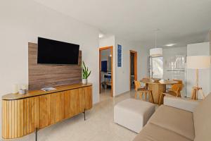 a living room with a flat screen tv on a wall at Callao Beach 2 in Arrieta