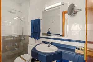 a bathroom with a sink and a toilet and a mirror at Callao Beach 2 in Arrieta +16 photos