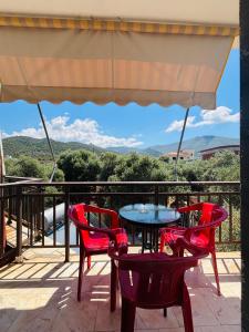 a table and chairs on a balcony with a view at Summer Rooms in Skala Kallirachis