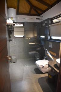 a bathroom with three sinks and a toilet at Red Panda Jungle Camp - A Unit of Davinchi Homes Pvt Ltd in Gyalzing