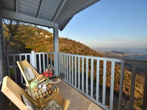 a porch with a bench and a view at Nof 10 in Amirim