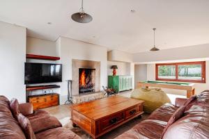 a living room with a couch and a table at Cloud 9 Luxury Eco Villa in Sedgefield