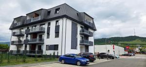 a blue car parked in front of a building at Studio S23 in Piatra Neamţ