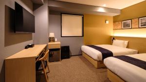a hotel room with two beds and a desk at HOTEL SUI HAMAMATSU by ABEST in Hamamatsu +65 photos