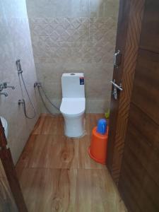 a bathroom with a toilet and a shower in it at Hotel Kunj Palace in Etah +17 photos