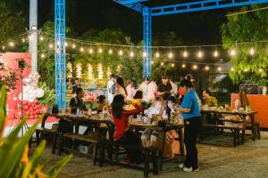 a group of people sitting at tables at a party at Mekong Camping Deluxe in Ấp Thanh Sơn (1) +65 photos