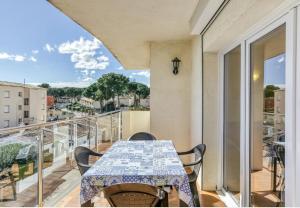 a balcony with a table and a view of a city at Escala Riells in L'Escala