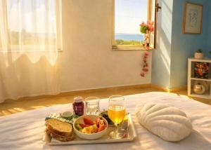 a tray of food and drinks on a bed at Durres Sun & Sea Luxury Apartment in Durrës