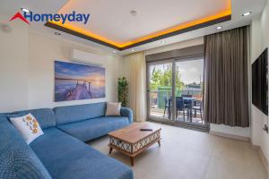 a living room with a blue couch and a table at Villa Elyse & Paradise in Orta