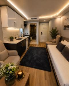 a living room with a couch and a kitchen at Art Karakoy Hotel in Istanbul +45 photos
