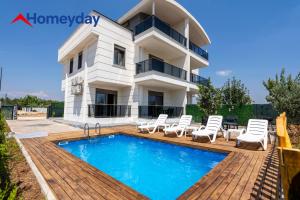 a villa with a swimming pool in front of a house at Villa Elyse & Paradise in Orta