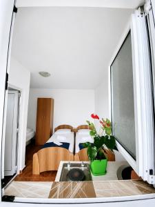 a room with a bed and a table with a tv at Apartments Buena Vista in Ulcinj