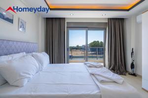 a bedroom with a white bed and a large window at Villa Elyse & Paradise in Orta +28 photos