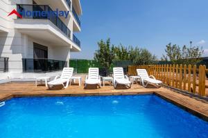 a group of chairs sitting next to a swimming pool at Villa Elyse & Paradise in Orta