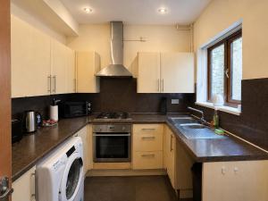 a kitchen with a sink and a stove top oven at 54 - Room 2 - Smart Tv in Swansea