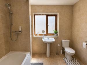 a bathroom with a sink and a toilet and a tub at 54 - Room 2 - Smart Tv in Swansea