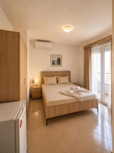 a bedroom with a large bed and a window at Vila Bolonja in Struga