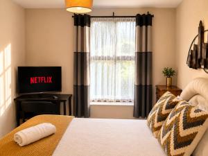 a bedroom with a bed and a window at 54 - Room 2 - Smart Tv in Swansea