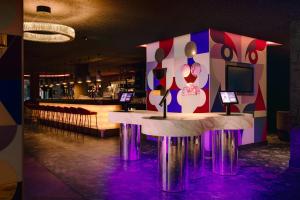 a restaurant with a table with a cake on it at NYX Hotel Amsterdam Rembrandt Square in Amsterdam