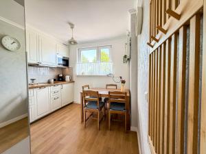 a kitchen with a table and a dining room at Apartament Biłgorajski przy Rynku in Biłgoraj