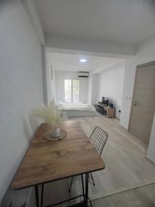 a room with a wooden table and a bedroom at Stefanelli Apartment in Struga +19 photos