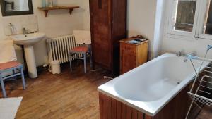a bathroom with a bath tub and a sink at Number 33 Village house in Rancon sleeps 4 in Rancon