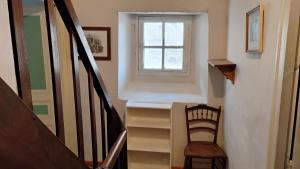 a stairway with a chair and a window at Number 33 Village house in Rancon sleeps 4 in Rancon
