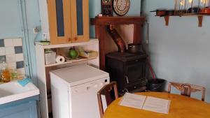 a kitchen with a wooden table and a stove at Number 33 Village house in Rancon sleeps 4 in Rancon +6 photos